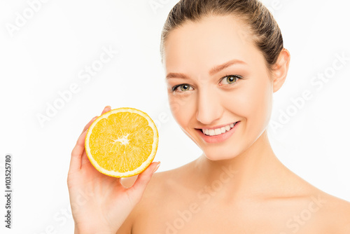 Young cute girl with nice smile and orange slice