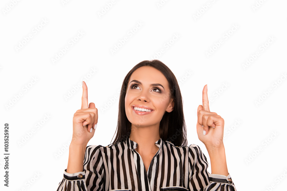 Smiling pretty businesswoman gesturing with fingers and pointing Smiling pretty businesswoman gesturing with fingers and pointing