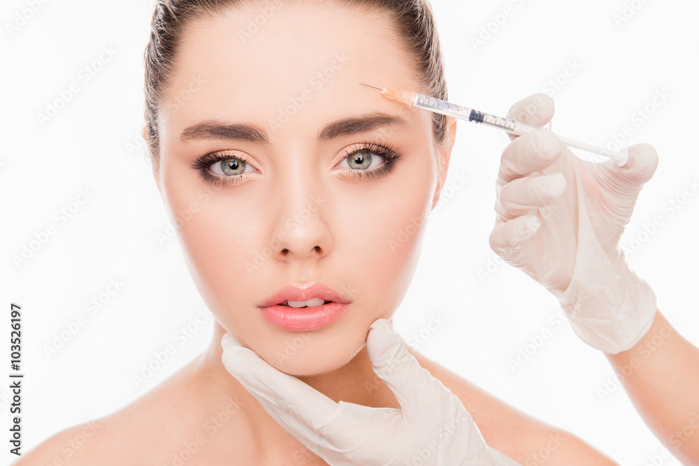 Portrait of attractive young woman getting cosmetic injection