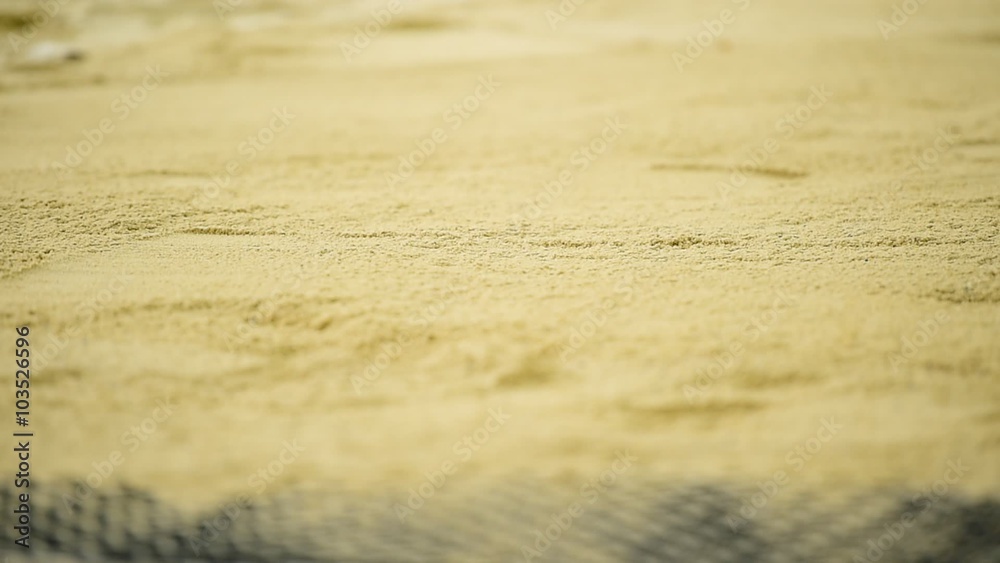 Athlete performing a long jump in the sand pit during athletics competition Athlete performing a long jump in the sand pit during athletics competition