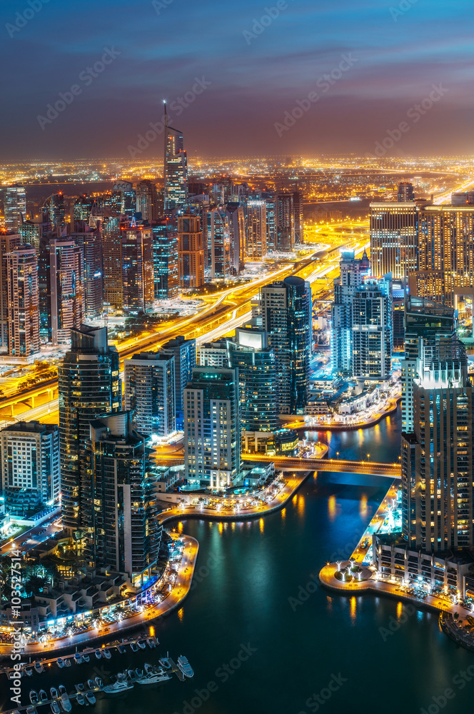 Obraz premium Fantastic rooftop skyline: illuminated architecture of a big city. Dubai Marina by night, United Arab Emirates.