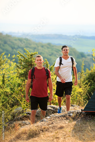 Two backpackers in the summer mountain