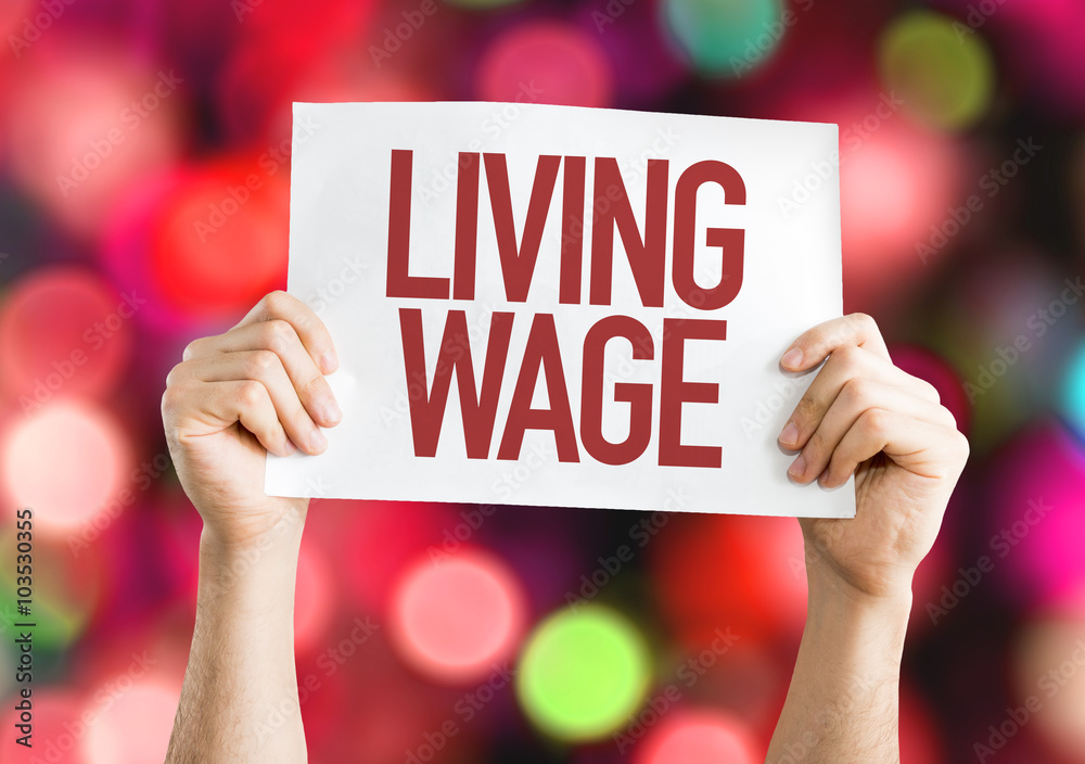 Living Wage placard with urban background Living Wage placard with urban background