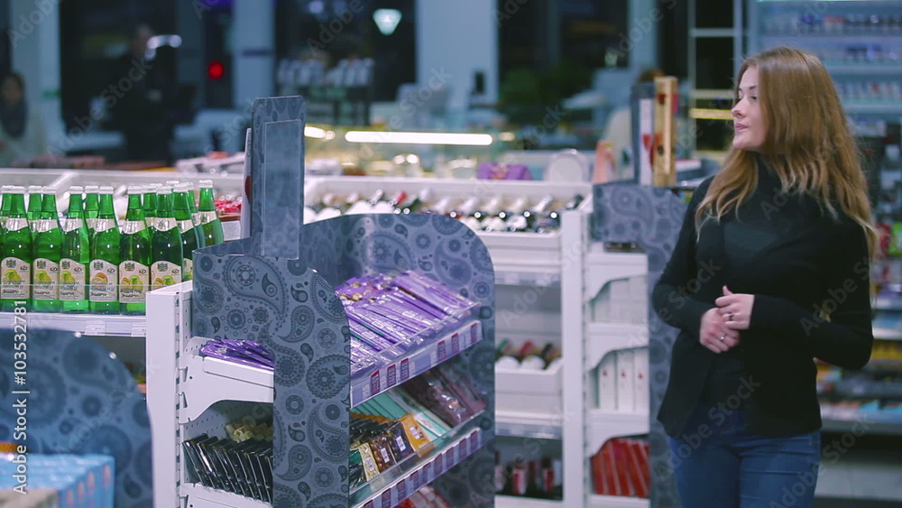 Girl stealing candy bar from shop