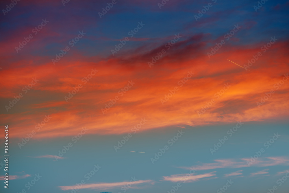 Red orange clouds in dramatic sunset sky