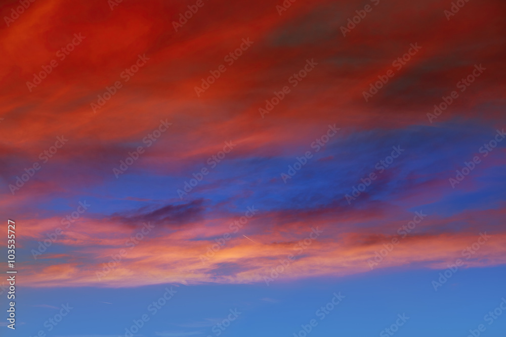 Red orange clouds in dramatic sunset sky