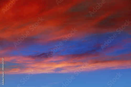 Red orange clouds in dramatic sunset sky