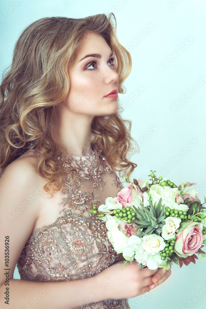 Beautiful bride in wedding dress holding bouquet and looking up Beautiful bride in wedding dress holding bouquet and looking up