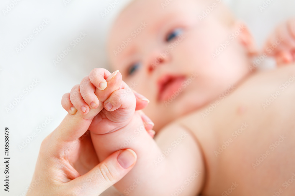 concept of parental love. baby hand holding  finger of mother
