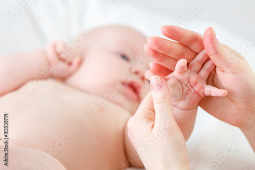 concept of parental love. baby hand holding finger of mother