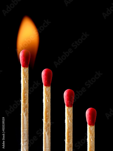 Burning match isolated on black background