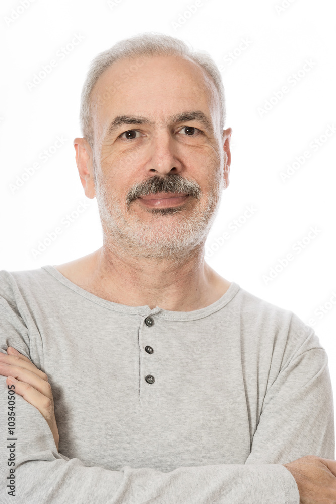 Close up portrait of a smiling attractive senior man looking dir