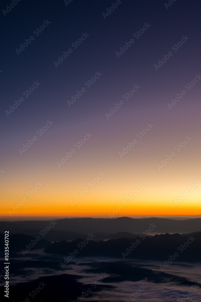 Dramatic sunset and sunrise sky on mountain and fog.