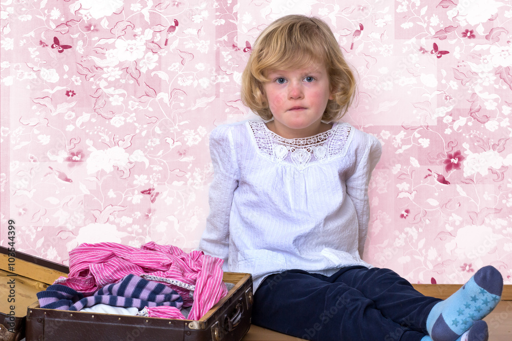 Little girl with clothes suitcase Little girl with clothes suitcase