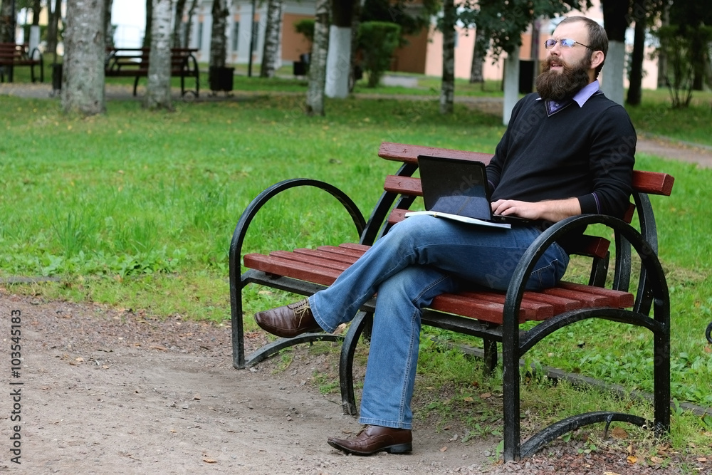 man reading books in the park man reading books in the park
