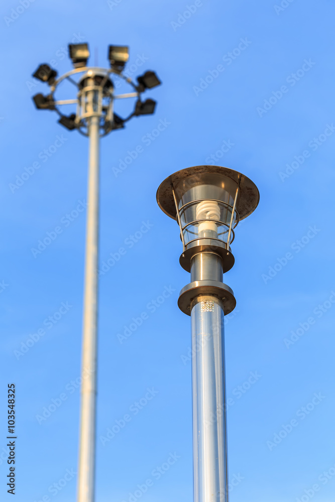 Stainless steel lamp pole at the road on blue sky Stainless steel lamp pole at the road on blue sky