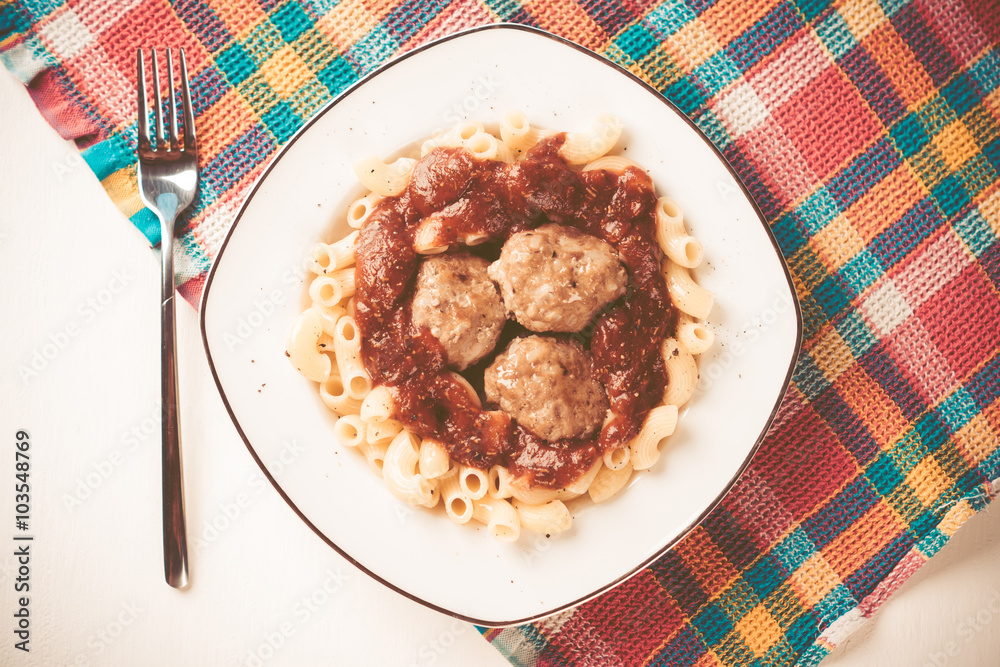 Pasta and meatballs with tomato sauce. Toned image.