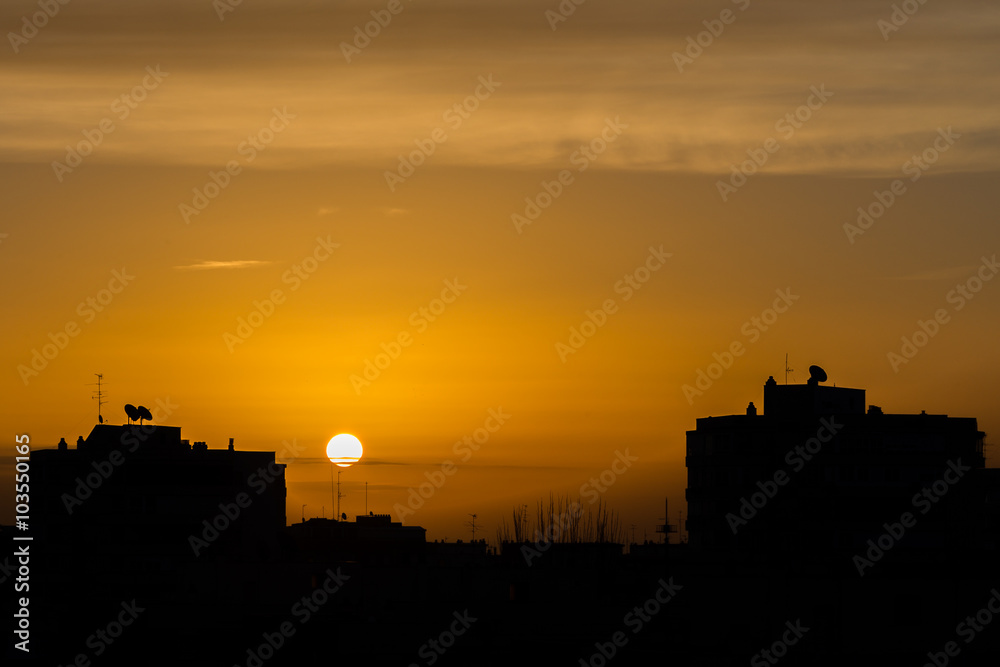 Silhouettes of buildings and television aerials at sunrise in Madrid