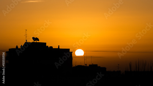 Silhouettes of buildings and television aerials at sunrise in Madrid