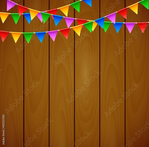 Birthday party with triangle flags on wooden background