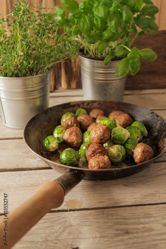 meatballs with cabbage and basil in a pan