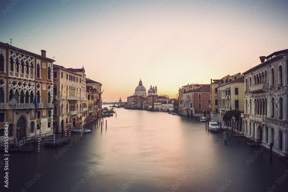 long time exposure of canal grande in Venice (Venezia) - Santa Maria Della Salute, Church of Health in dusk twilight at Grand canal Venice, Italy, Europe, vintage filtered style
