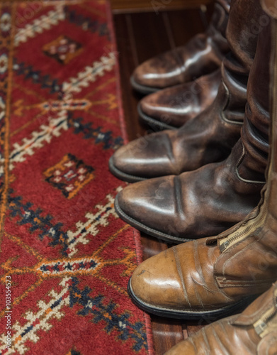 Worn Leather Boots with Patterned Carpet