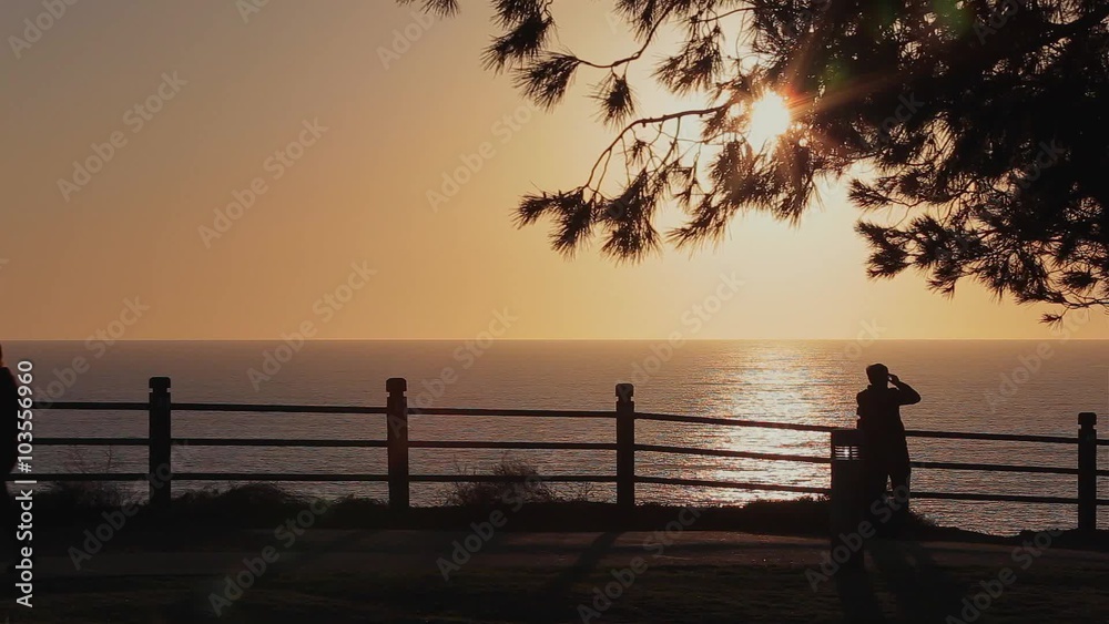 People Walking Ocean View / A silhouette of people looking at an ocean view during sunset/sunrise. People Walking Ocean View / A silhouette of people looking at an ocean view during sunset/sunrise.