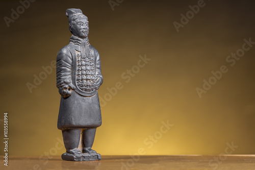 Terracotta figurine of ancient chinese warrior on orange background