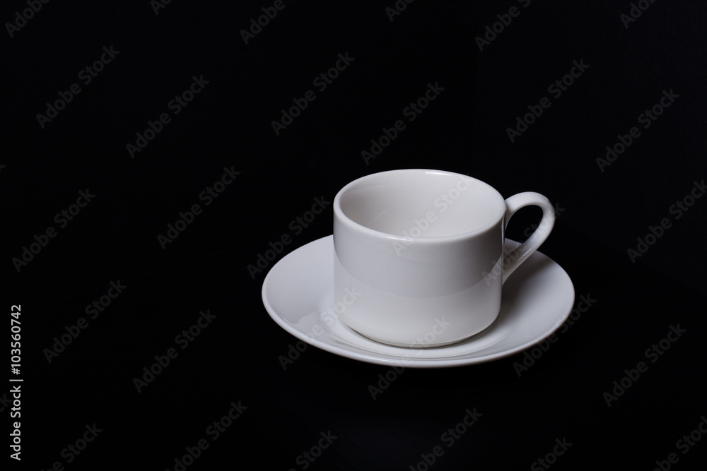 Cup and saucer on a black background Cup and saucer on a black background
