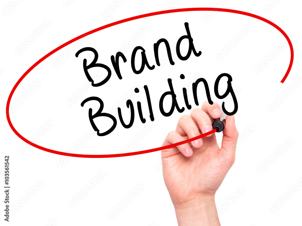 Man Hand writing Brand Building with black marker on visual scre Man Hand writing Brand Building with black marker on visual scre
