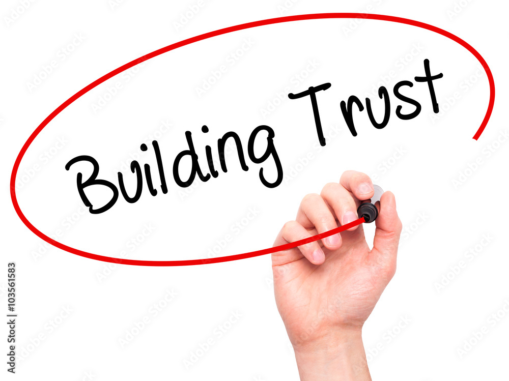Man Hand writing Building Trust with black marker on visual scre