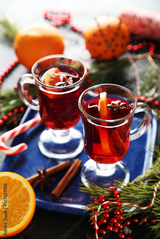 Mulled wine in glass on black wooden table Mulled wine in glass on black wooden table