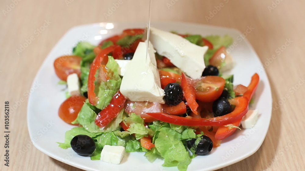 Fresh salad with olive oil isolated on white background, pouring salad dressing into cutting vegetables, organic food, healthy nutrition concept. Fresh salad with olive oil isolated on white background, pouring salad dressing into cutting vegetables, organic food, healthy nutrition concept.