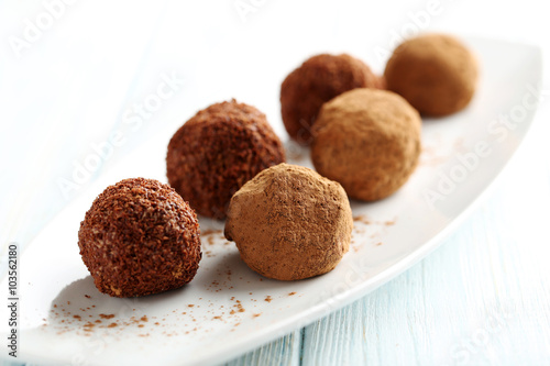 Sweet chocolate truffle on a blue wooden table