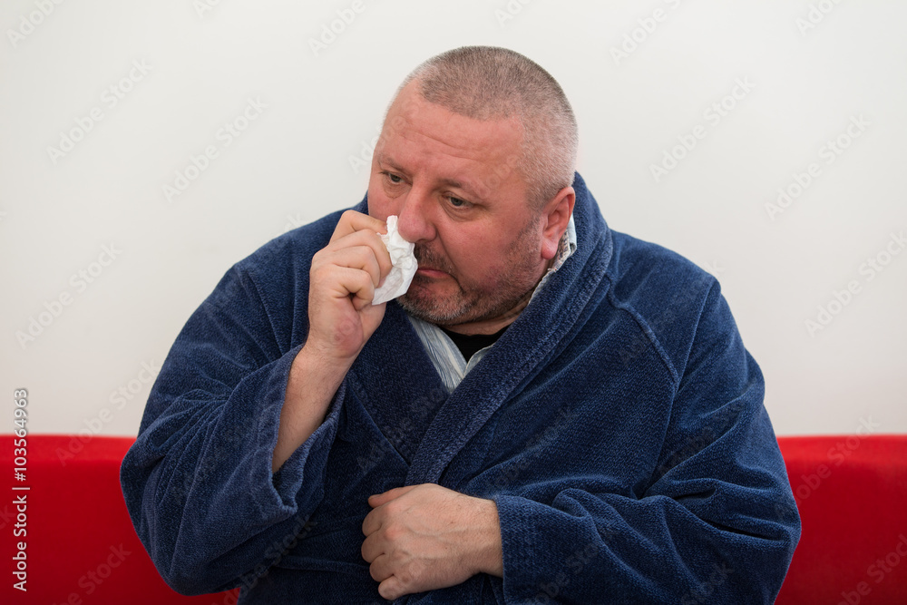 Close-up of a man with tissue in his nose. Close-up of a man with tissue in his nose.