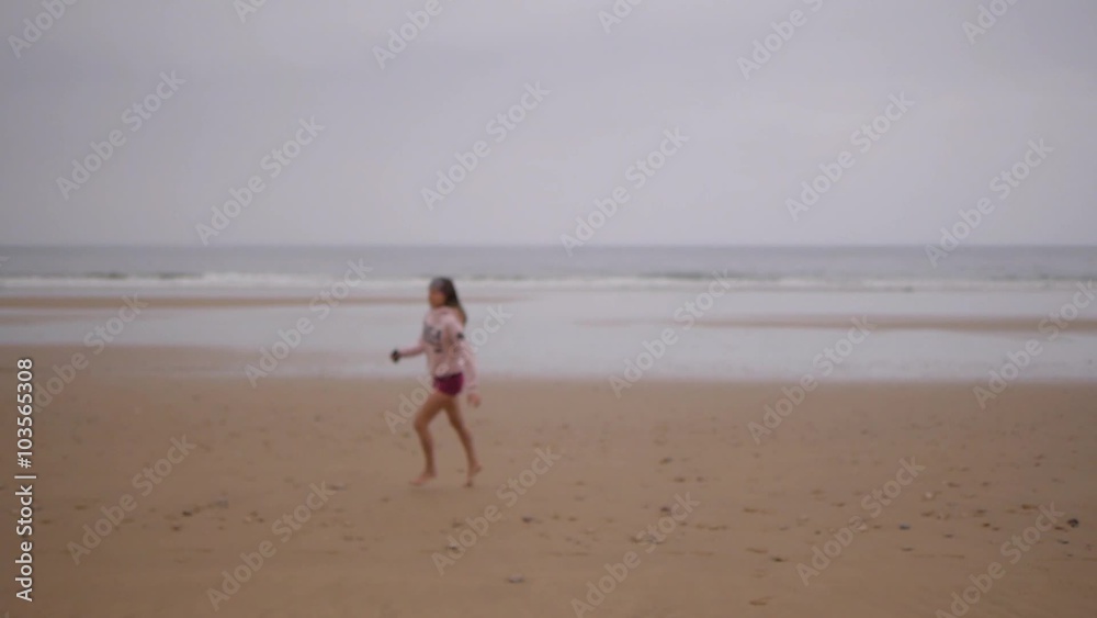 Beach woman running to water in dress at sunset raising arms enjoying freedom during summer holidays vacation travel Beach woman running to water in dress at sunset raising arms enjoying freedom during summer holidays vacation travel