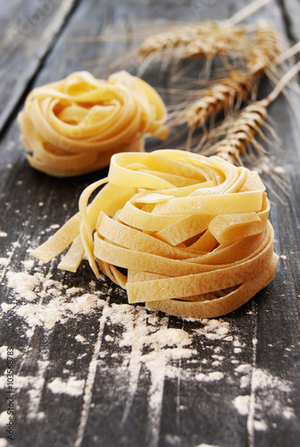 Uncooked pasta with flour on the table  selective focus