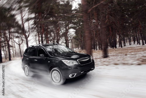 Black car speed drive on off road at winter daytime