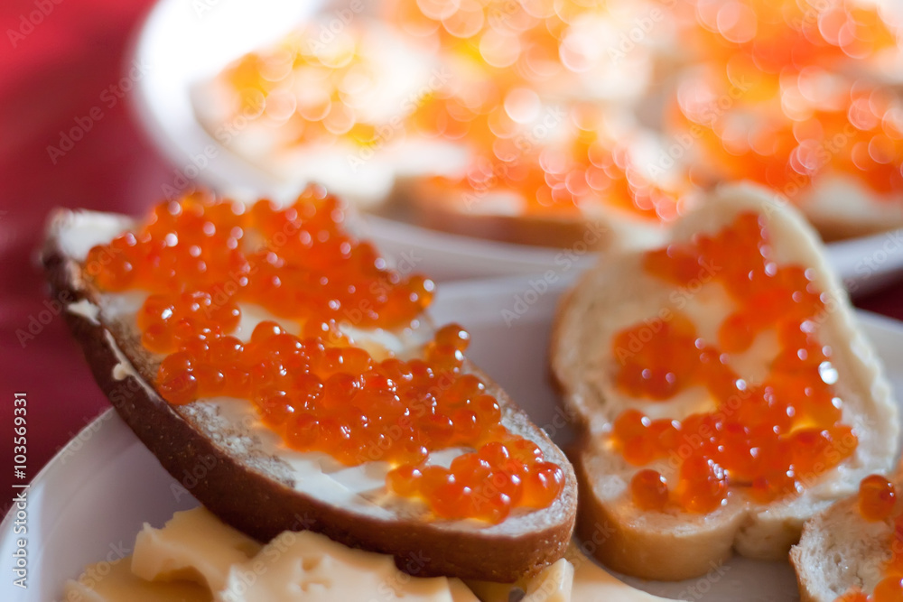 Red caviar on white plate close-up Red caviar on white plate close-up