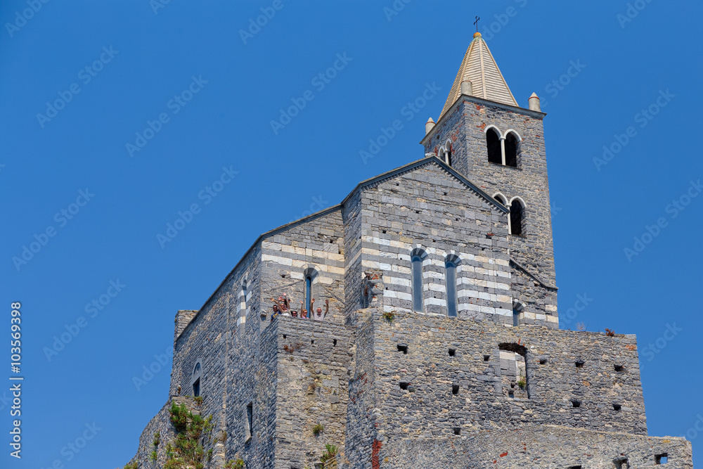 Church of San Pietro perched on its walls, seen from below