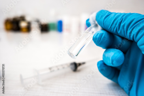 Doctor's hands in blue robber gloves