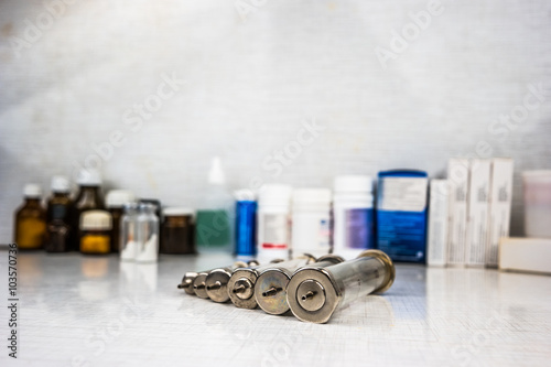 Syringe with glass vials and medications pills