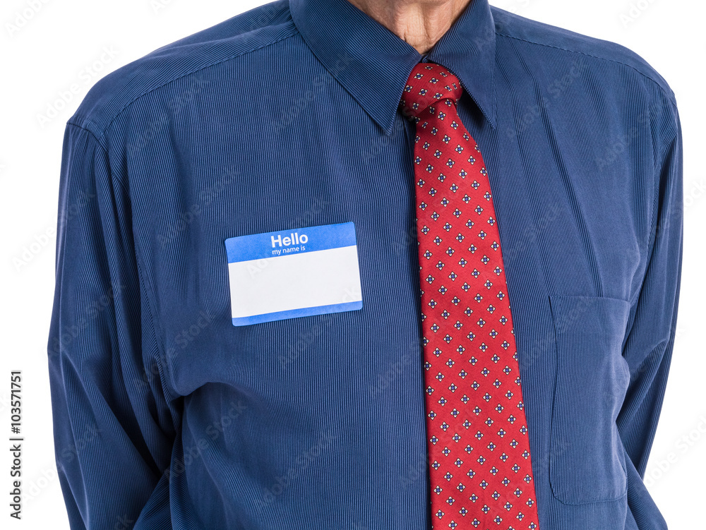 Photo of senior man in a blue shirt and red tie wearing a "Hello My Name  Is" name tag. Stock Photo | Adobe Stock