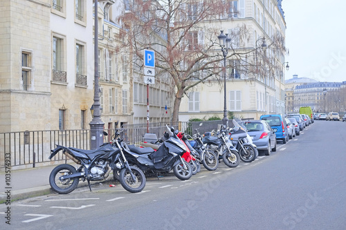 Paris, France, February 9, 2016: motorcycle parking on a street in a center of Paris, France. Motorcycles are very popular transport in Paris