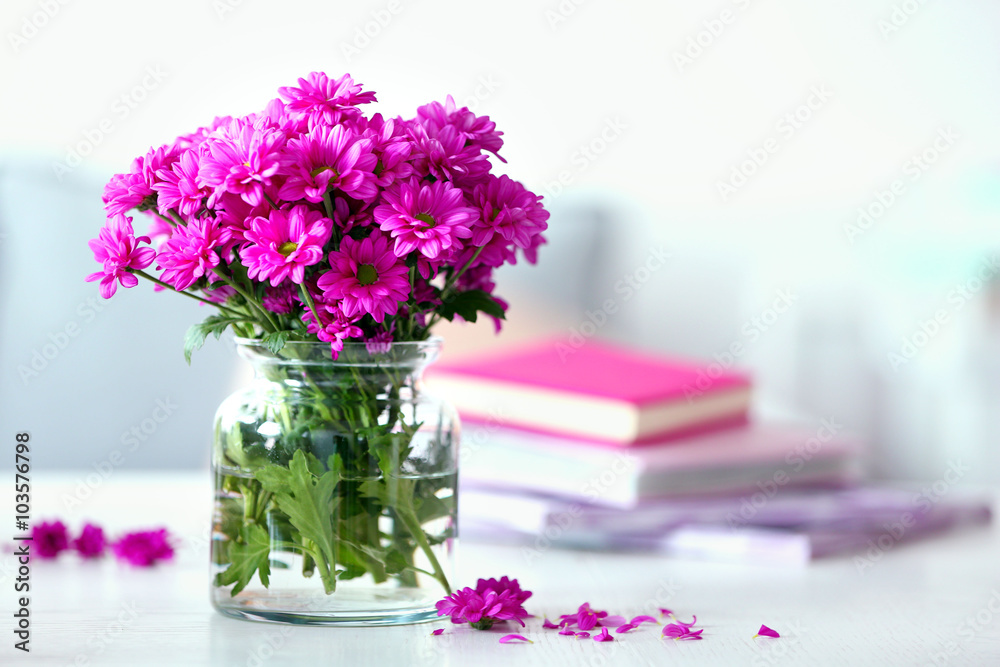 Beautiful flowers in vase on table in room Beautiful flowers in vase on table in room