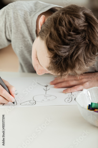 Teenage Boy Draw Something on White Paper