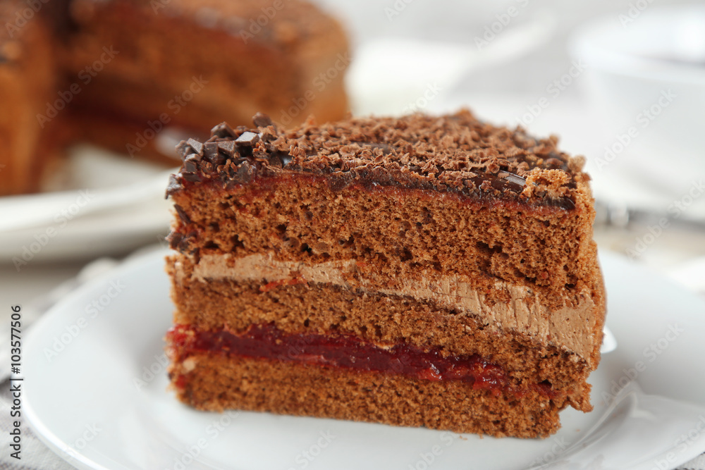 Sliced chocolate cake on plate, on wooden table background Sliced chocolate cake on plate, on wooden table background