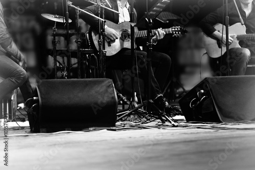 Black and white photo of a guitarist playing guitar at the stage