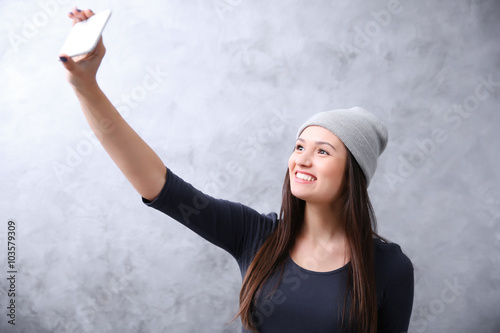 Young girl in hat taking ph...